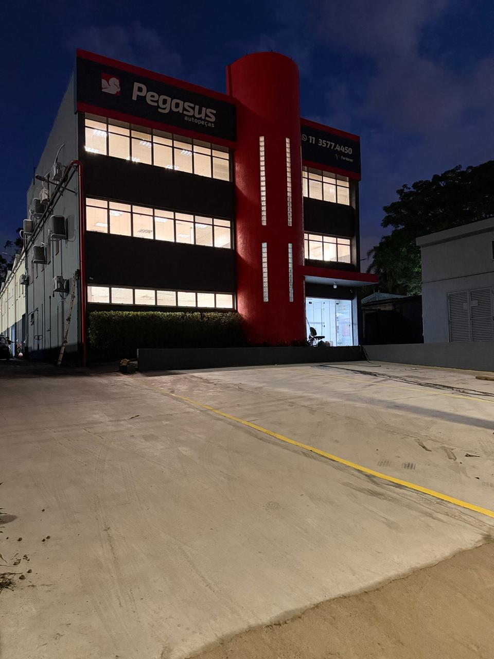 Fachada da Pegasus Autopeças ao anoitecer